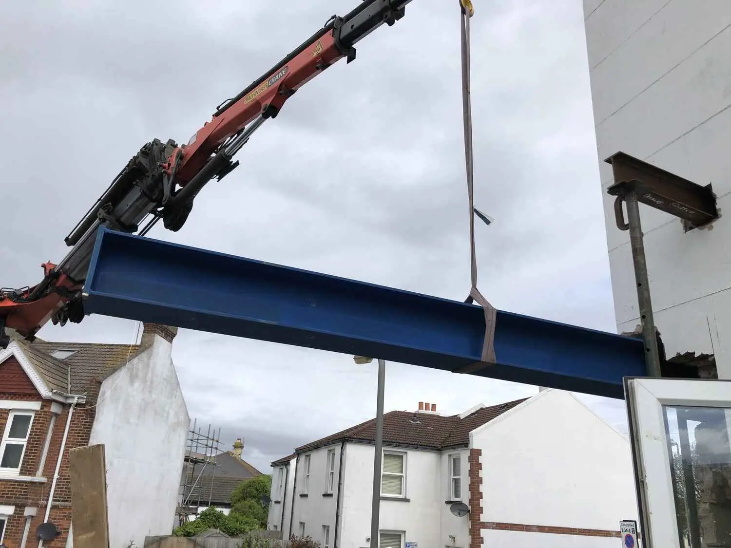 A crane lifting a steel beam into place