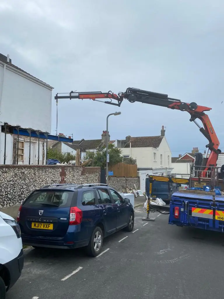 The steel beam being guided into position