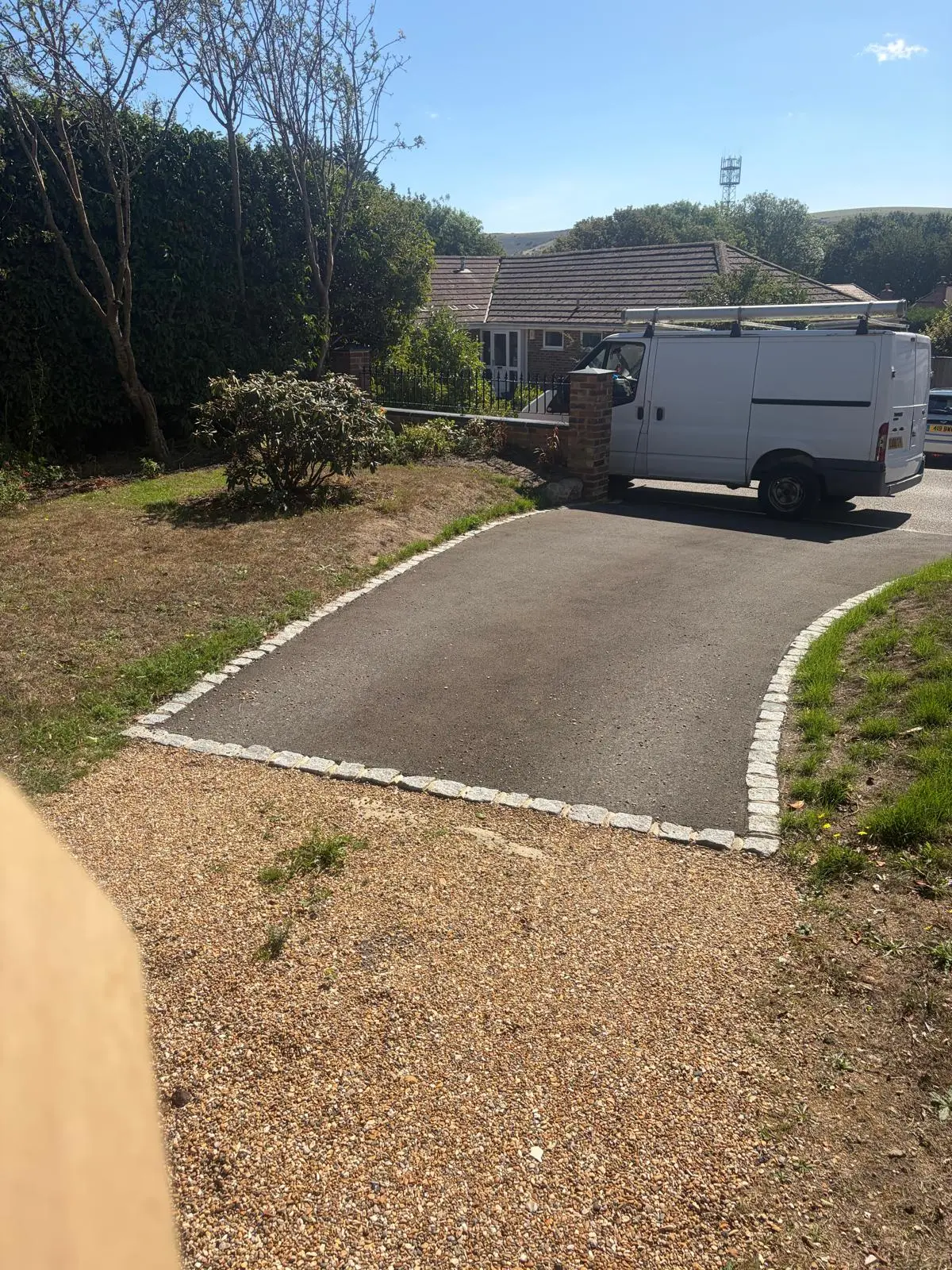 The driveway entrance with granite sett edging, leading up to the house