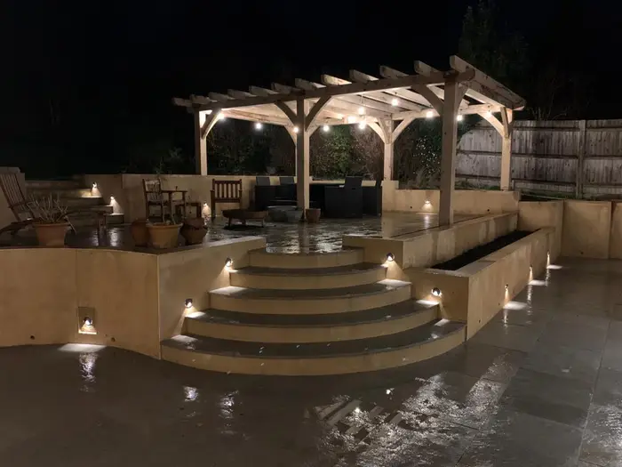 The finished garden lit up at night